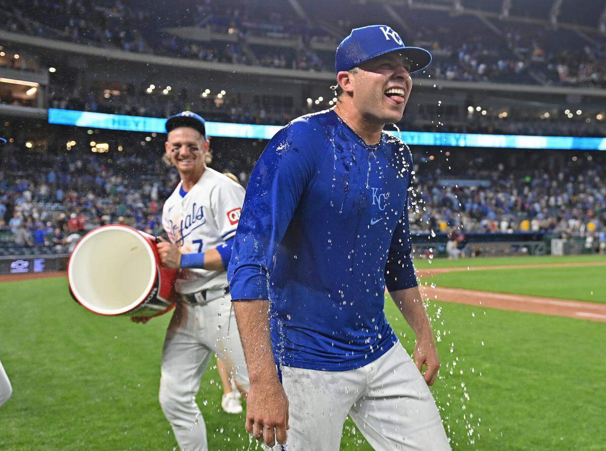 Kansas City Royals relief pitcher Sam Long (73) reacts after receiving a victory splash from Bobby Witt Jr. (7) after beating the Cleveland Guardians at Kauffman Stadium on June 27, 2024 in Kansas City.