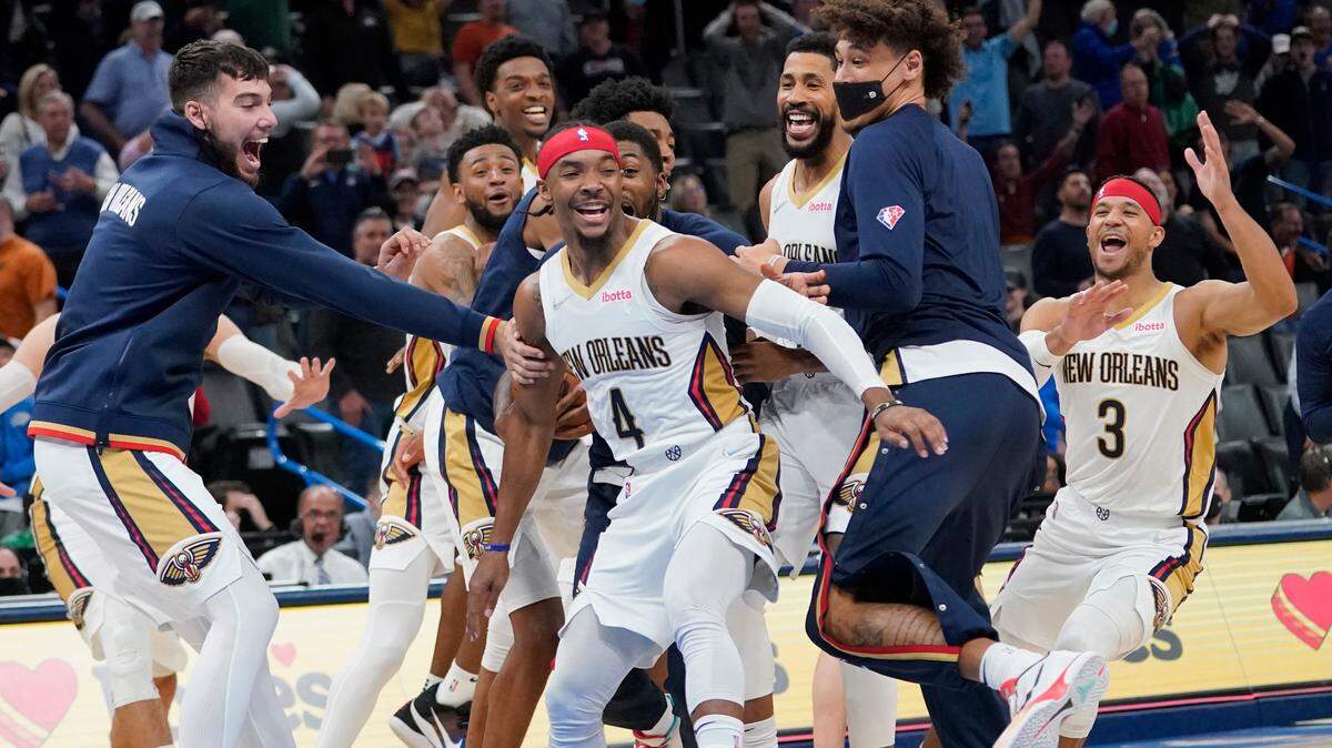 New Orleans Pelicans guard Devonte’ Graham (4) celebrates with teammates after hitting the game winning basket against the Oklahoma City Thunder, Wednesday, Dec. 15, 2021, in Oklahoma City.