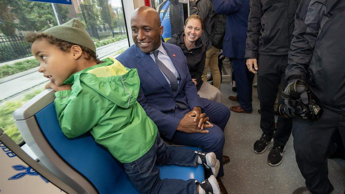 Kansas City Mayor Quinton Lucas and his wife, Katherine Carttar, right, watch their son, Bennett Carttar Lucas, look out the window during the inaugural ride of the KC Streetcar Main Street extension on Friday, October 24, 2025. The grand opening celebrated the addition of a Plaza stop and a stop at the University of Missouri-Kansas City. 