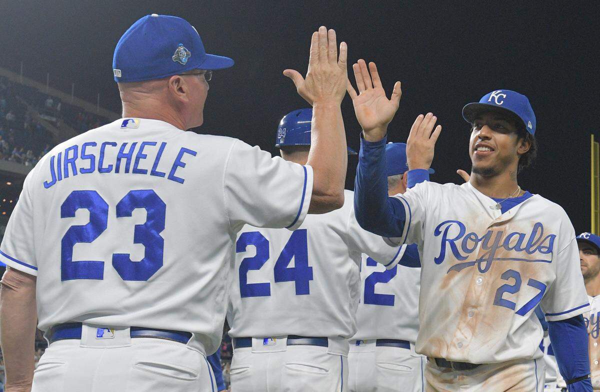 Kansas City Royals shortstop Adalberto Mondesi (27) is congratulated by third base coach Mike Jirschele (23) after the win over the Cleveland Indians the Cleveland Indians at Kauffman Stadium on Sept. 29, 2018.