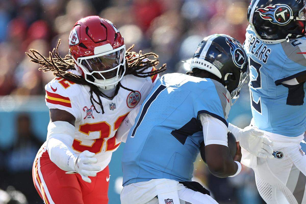 Kansas City Chiefs linebacker Nick Bolton (No. 32) tackles Tennessee’s Cam Ward during an NFL Week 16 game against the Titans at Nissan Stadium in Nashville on Sunday, Dec. 21, 2025.