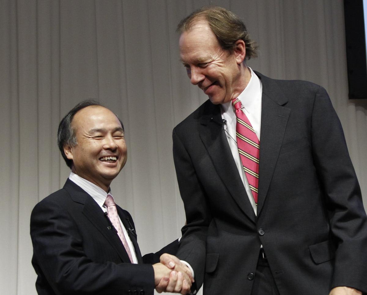 Softbank Corp. President Masayoshi Son, left, and Sprint Nextel Corp. Chief Executive Dan Hesse shook hands during their joint press conference in Tokyo Monday, Oct. 15, 2012. Tokyo-based mobile Softbank reached a deal with Sprint to acquire a majority stake in the U.S. wireless company for $20.1 billion in the largest ever foreign acquisition by a Japanese company.