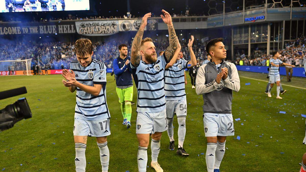 Sporting Kansas City midfielder Jake Davis (17), forward Johnny Russell (7) and midfielder Felipe Hernandez (21) celebrate defeating St. Louis City SC in the 2023 MLS Cup Playoffs at Children’s Mercy Park on Nov. 5, 2023.