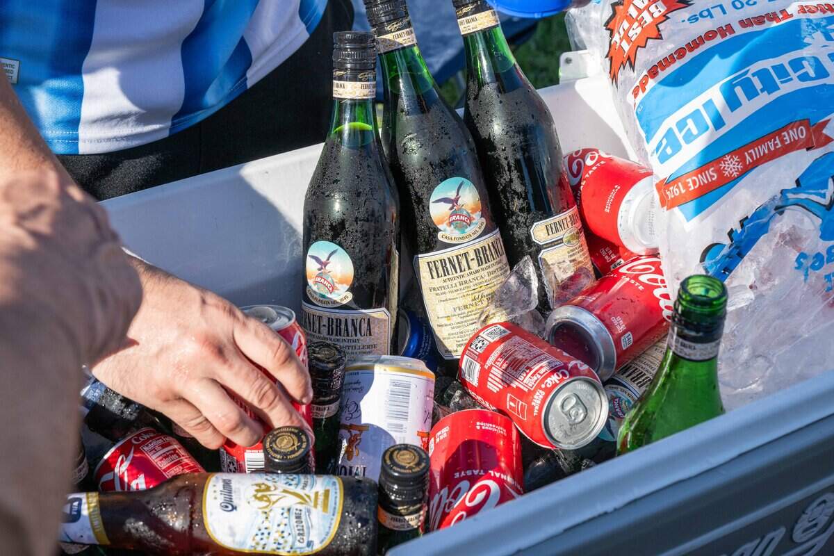 Fernet and Coca-Cola sits on ice as Argentina fans rally at Mill Creek Park on Friday, June 10, 2026. Argentina and superstar Lionel Messi will face Switzerland at Kansas City Stadium on Saturday for a chance to advance to the semifinals of the World Cup.