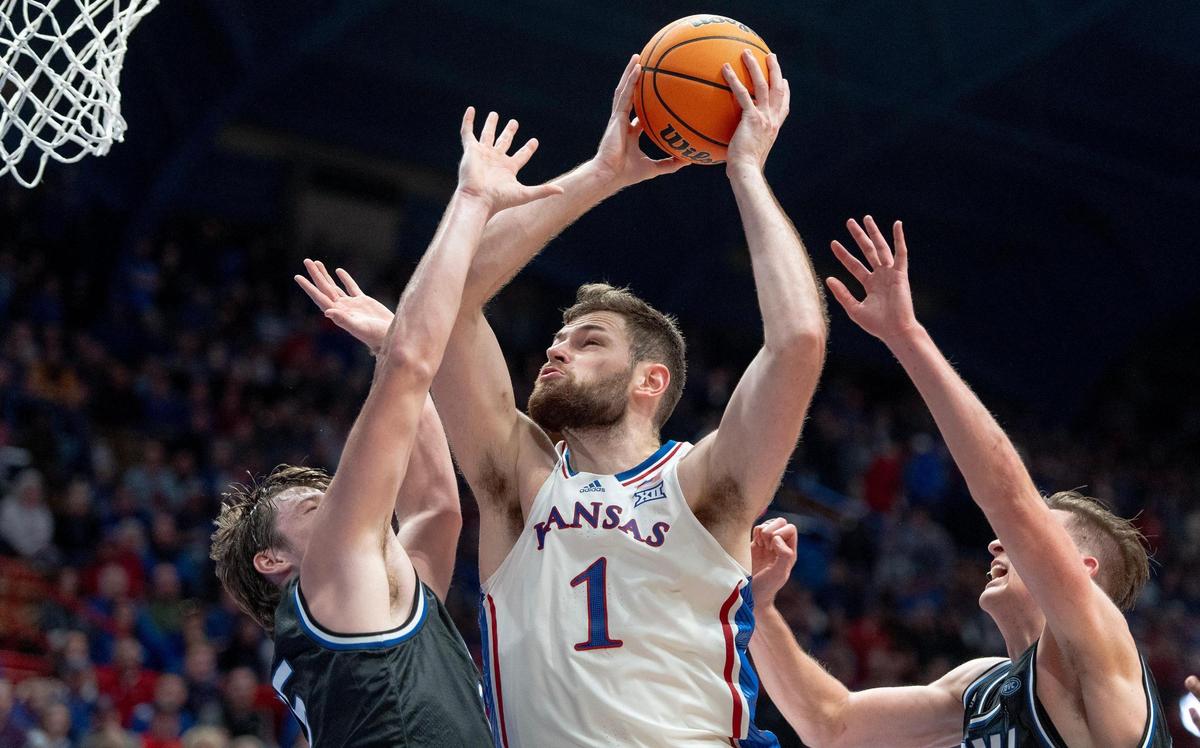 Kansas Jayhawks center Hunter Dickinson (1) goes to the hoop against Eastern Illinois Panthers guard Dan Luers, left, during an NCAA college basketball game on Tuesday, Nov. 28, 2023, in Lawrence, Kan.