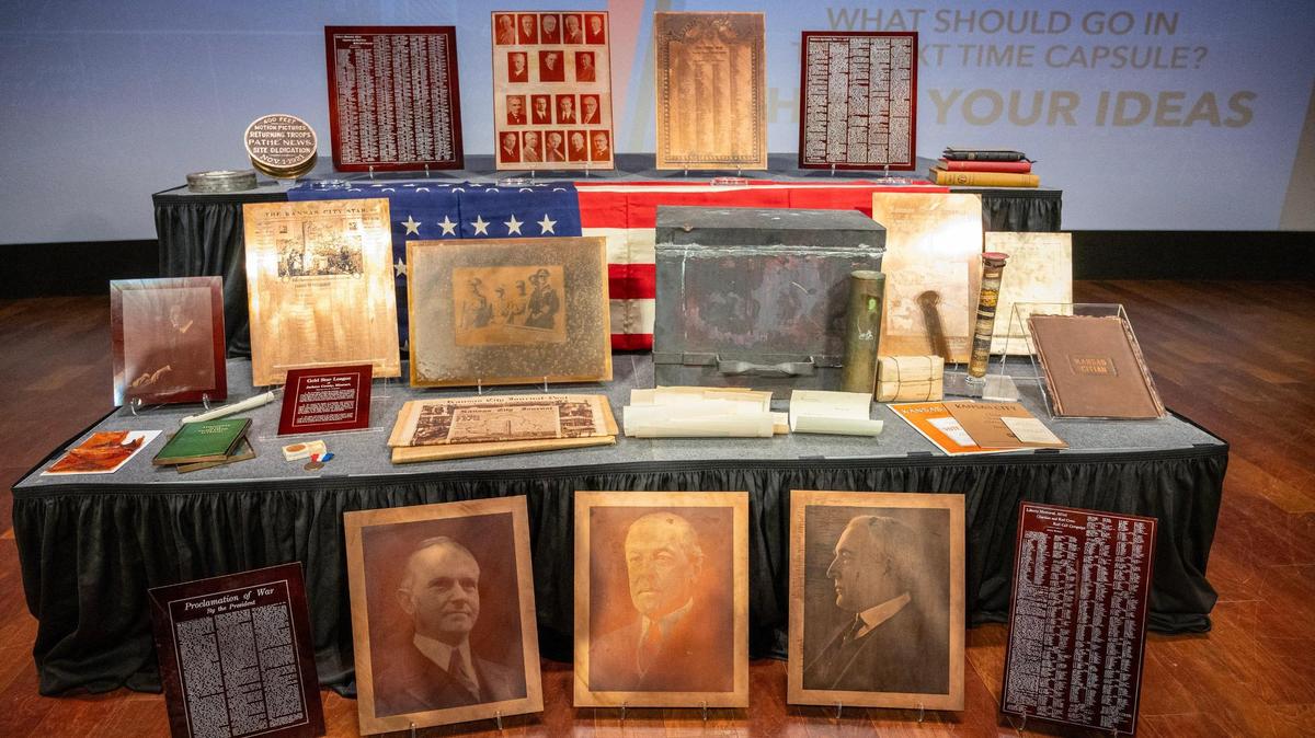 Artifacts recovered from a 100-year-old time capsule are displayed on stage during an unveiling ceremony at the National WWI Museum and Memorial on Wednesday, Oct. 16, 2024, in Kansas City.