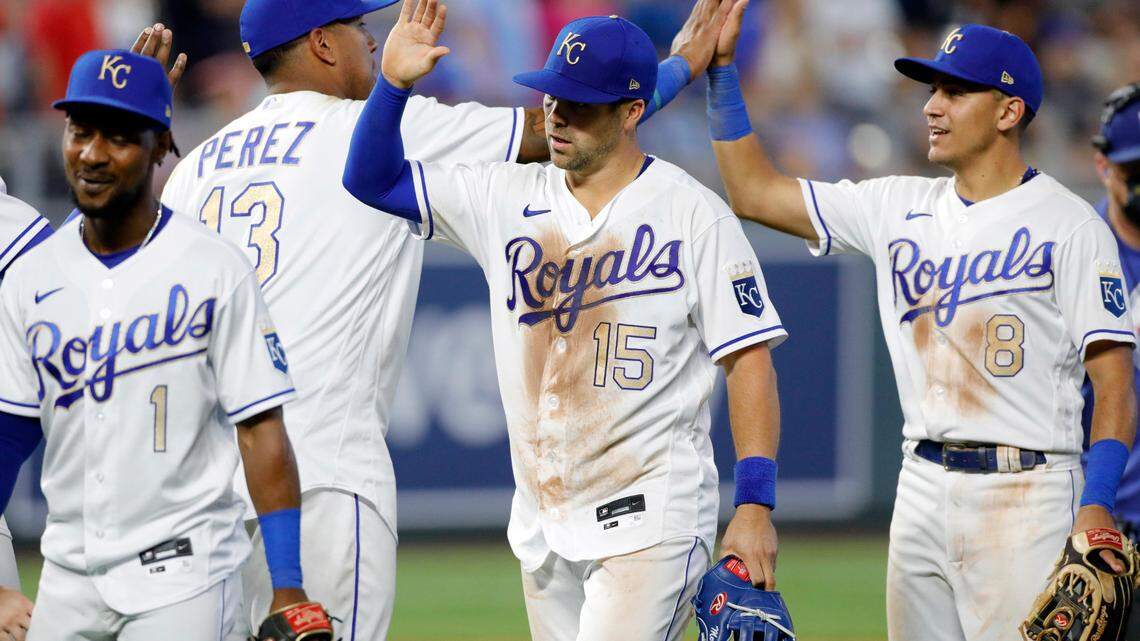 Kansas City Royals’ Jarrod Dyson (1) Salvador Perez (13) Whit Merrifiled (15) and Nicky Lopez (8) celebrate their win over the Baltimore Orioles at the end of a baseball game at Kauffman Stadium in Kansas City, Mo., Friday, July 16, 2021. (AP Photo/Colin E. Braley)