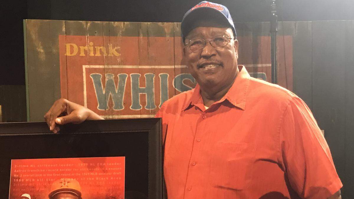 J.R. Richard stands next to his Negro Leagues Baseball Museum picture dedicated to him before his Hall of Game induction on Saturday, June 9.