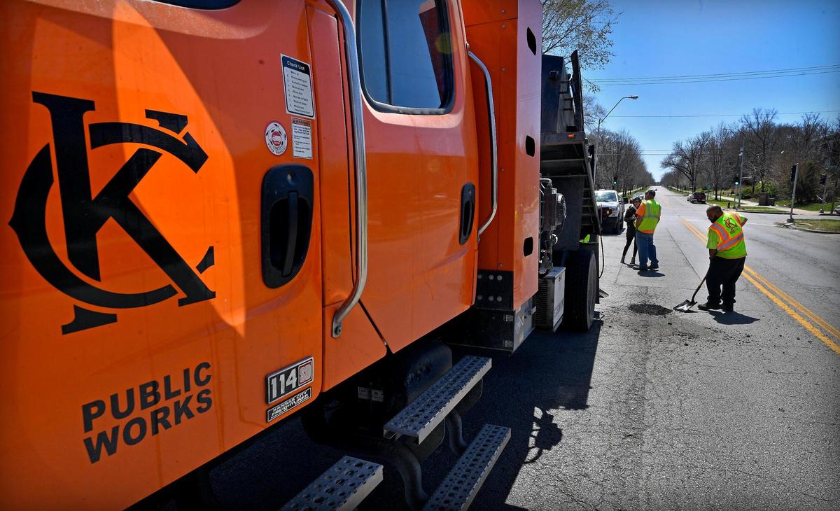 Jason Brown, an equipment operator for Kansas City Public Works, is seen at work on Benton Boulevard, near 25th Street on Kansas City’s East Side. The city public works department lost nearly half its pothole-focused employees in the past two years, leaving remaining crews with a backlog of patching requests alongside other maintenance work.