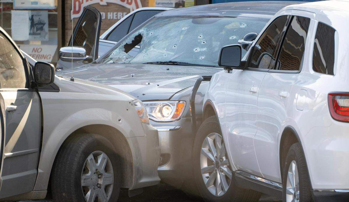 Two KCKPD vehicles remain blocking a Chrysler 300 in the parking lot of Fast Freds Market after police tried to arrest suspects in an undercover investigation of fentanyl dealing Wednesday in Kansas City, Kansas.