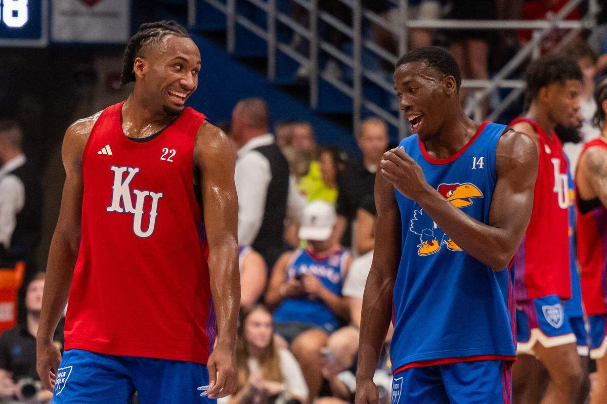 Freshman Kansas Jayhawks guard Darryn Peterson, left, shares a laugh at halfcourt with KU teammate Melvin Council Jr. during the men's scrimmage at Late Night in the Phog, on Friday, Oct. 17, 2025, in Lawrence, Kan.