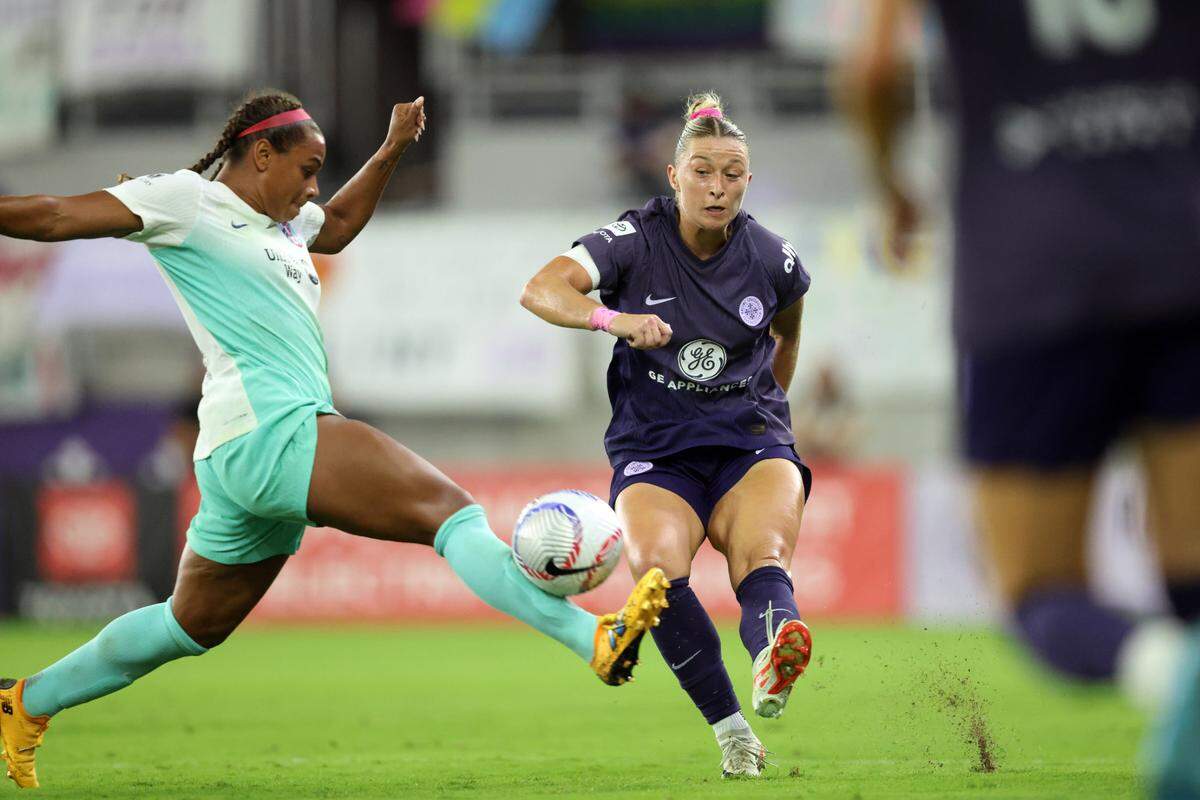 Racing Louisville FC defender Courtney Petersen, right, battles Kansas City Current forward Michelle Cooper for the ball during Saturday night’s NWSL match in Louisville, Ky.