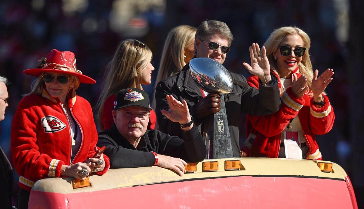 Tammy Reid, left, head coach Andy Reid, Chiefs owner Clark Hunt and Tavia Shackles ride a bus during the Kansas City Chiefs Super Bowl LVIII victory parade Wednesday, Feb. 14, 2024, in Kansas City.