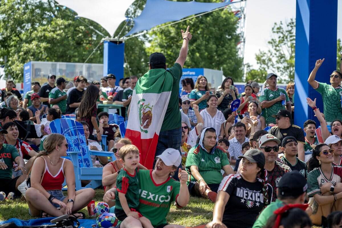 Fans cheer after Mexico scores a goal in the second half of a FIFA World Cup match against South Africa while watching the game on a video screen at the FIFA Fan Festival on Thursday, June 11, 2026, in Kansas City.