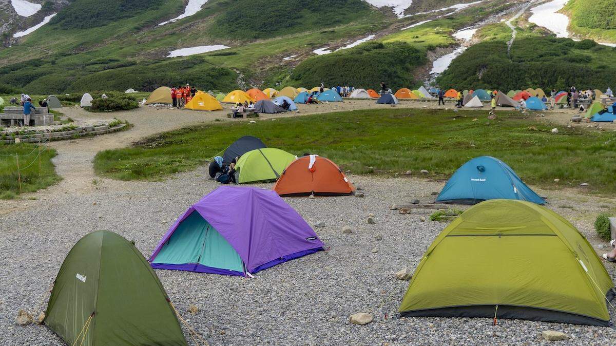 Colorful tents at the Murodo Permitted Camping Area located in the Northern Japanese Alps, Tate Mountains, Toyama Prefecture, Japan on July 23, 2025. (Photo by Antoine Boureau / Hans Lucas via AFP)