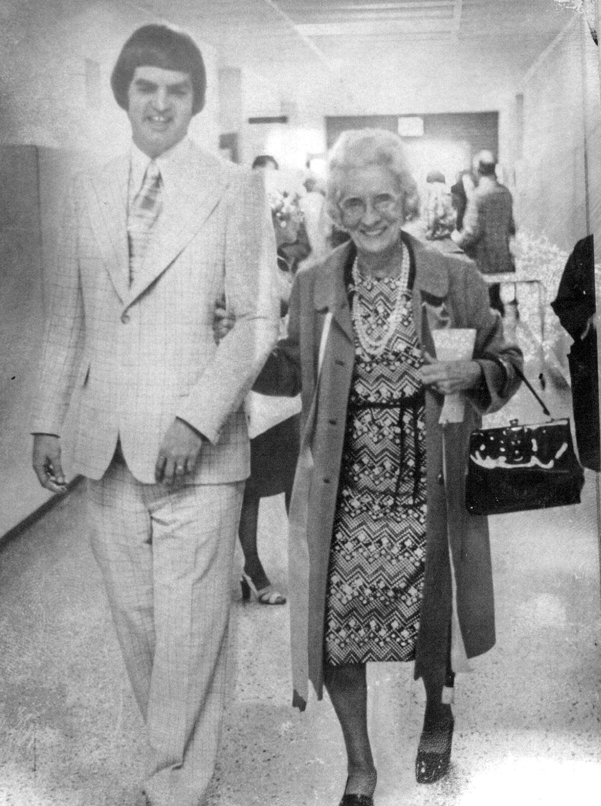 Mrs. Gladys A. Kelce, widow of L. Russell Kelce, tours the business school named in her honor in Pittsburg, Kansas, guided by Dr. Richard K. Hay. Her generous donation made the building’s renovation possible.