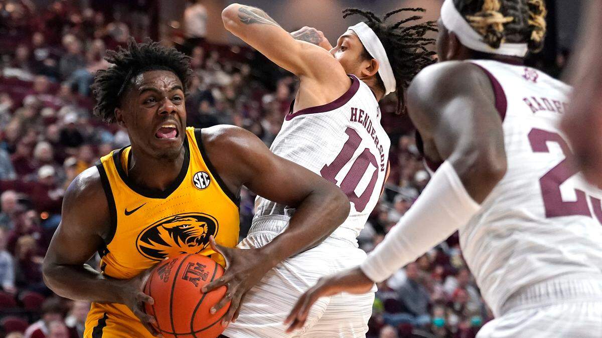 Missouri forward Kobe Brown (24) is fouled by Texas A&M forward Ethan Henderson (10) as he drives the lane during the first half of an NCAA college basketball game, Saturday, Feb. 5, 2022, in College Station, Texas. (AP Photo/Sam Craft)