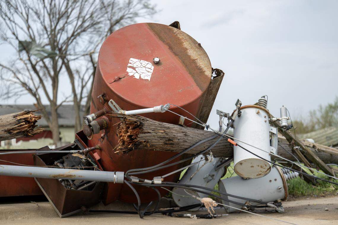 Downed power lines damaged in the tornado on Monday, littered the parking lot at the Sunoco Lake-N-Dale on Tuesday, April 14, 2026, in Hillsdale, Kansas. 