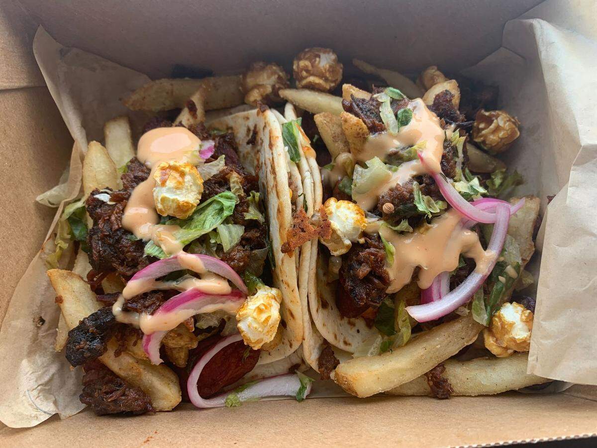 The new ‘Taste of The K’ taco, which features a charred hot dog wrapped in a cheeseburger quesadilla, brisket, crackerjacks and more.