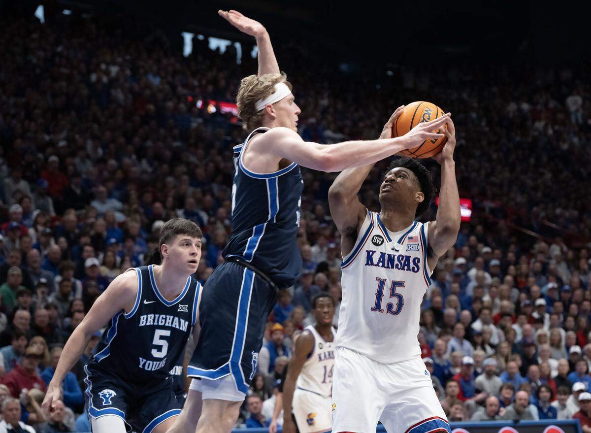 Kansas Jayhawks forward Bryson Tiller (15) is guarded by BYU Cougars guard Richie Saunders (15) in the second half at Allen Fieldhouse on Saturday, Jan. 31, 2026, in Lawrence.