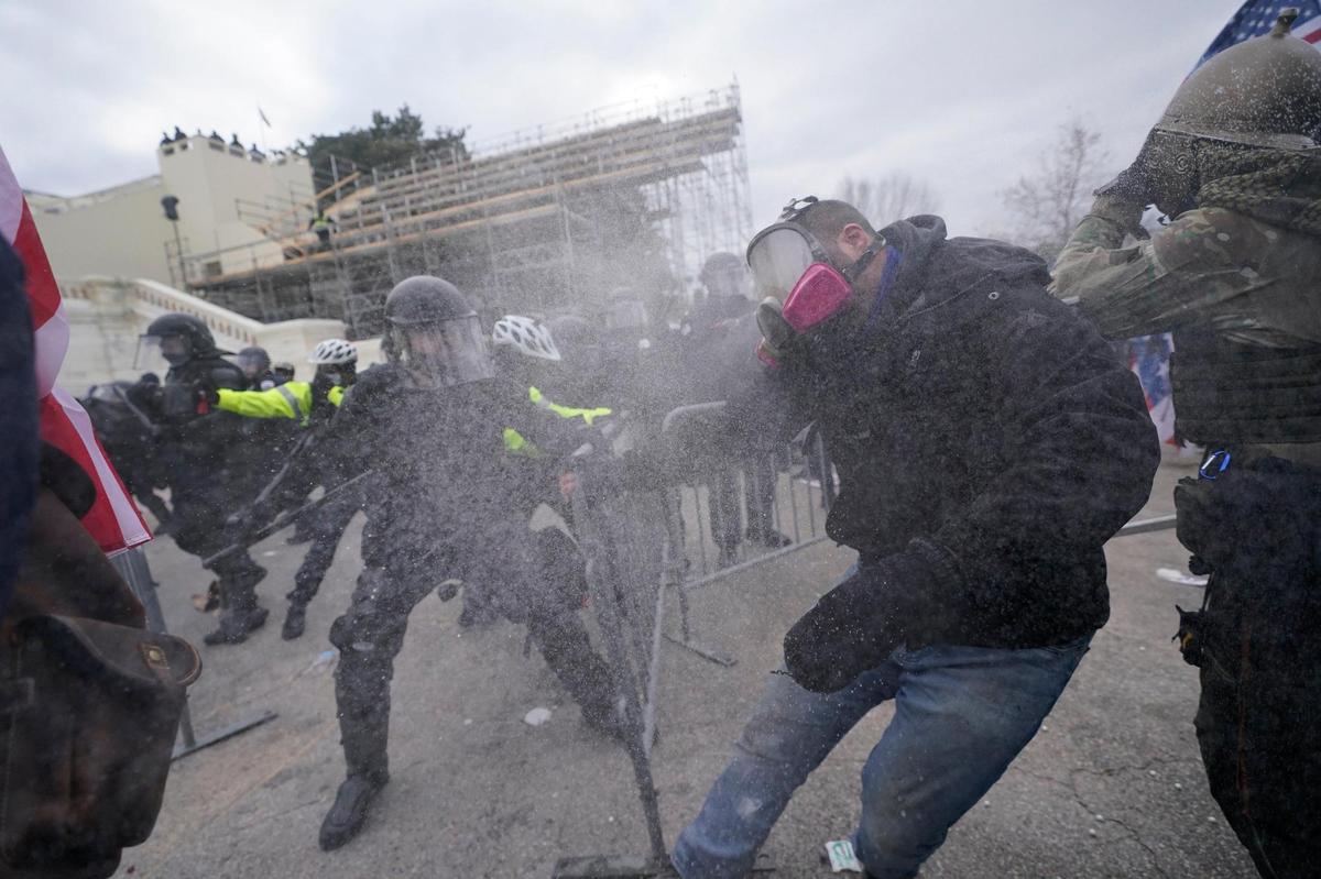 Trump supporters try to break through a police barrier, Wednesday, Jan. 6, 2021, at the Capitol in Washington. As Congress prepares to affirm President-elect Joe Biden’s victory, thousands of people have gathered to show their support for President Donald Trump and his claims of election fraud. (AP Photo/Julio Cortez)