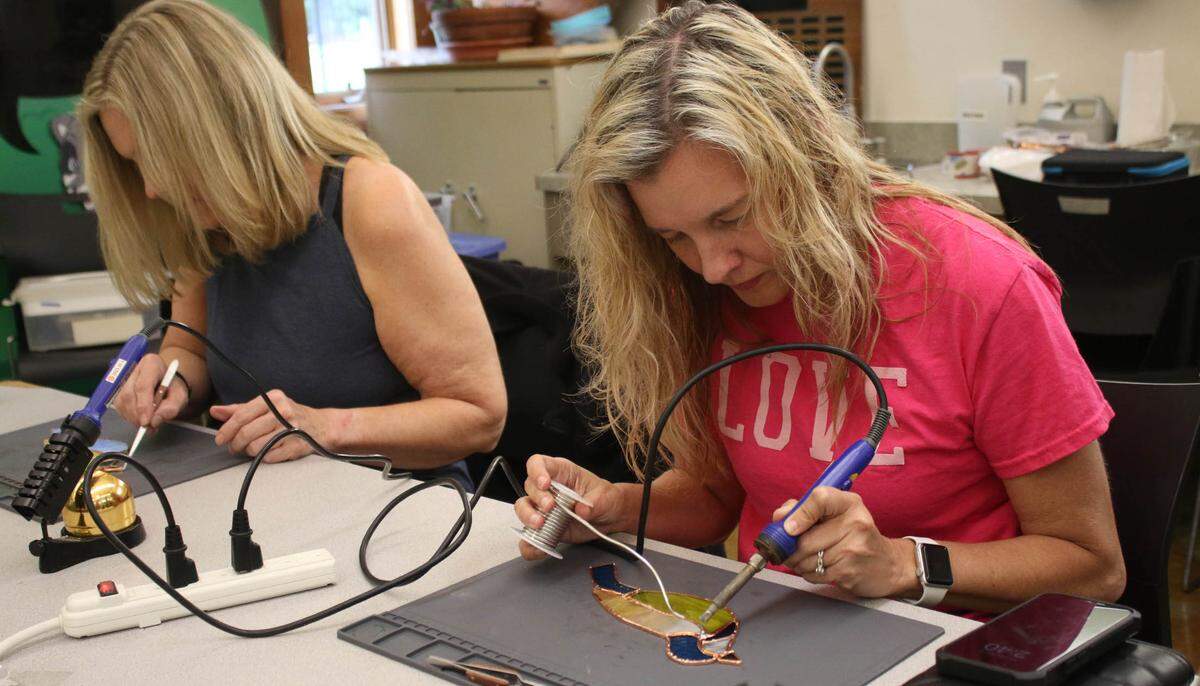 Lee’s Summit resident Erika Jump works on soldering during a stained glass class at the Overland Park Arboretum.
