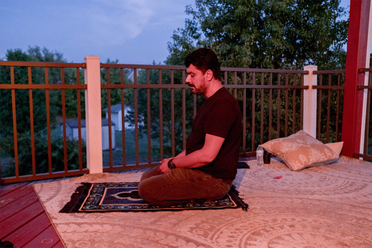 Lemar holds prayer on the balcony of his home the night before he leaves for Texas.