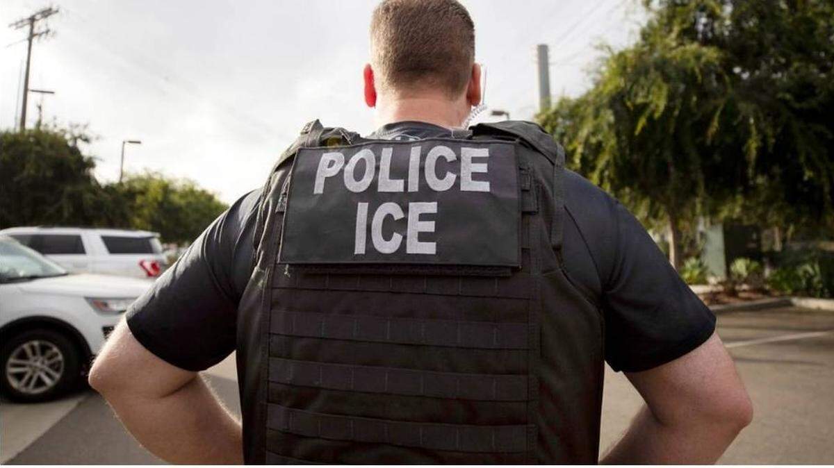 A U.S. Immigration and Customs Enforcement (ICE) officer looks on during an operation in Escondido, Calif.