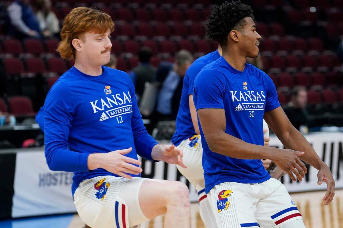 KU’s Chris Teahan (left) warmed up before the Jayhawks’ Sweet 16 game March 25 in Chicago.
