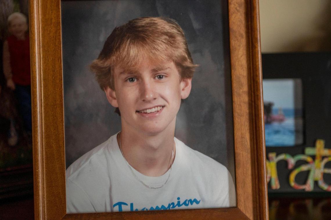A framed photograph of 16-year-old Cooper Davis sits on a shelf at the Davis family home in Shawnee. He had just started his junior year at Mill Valley High School in the De Soto school district when he died last August.