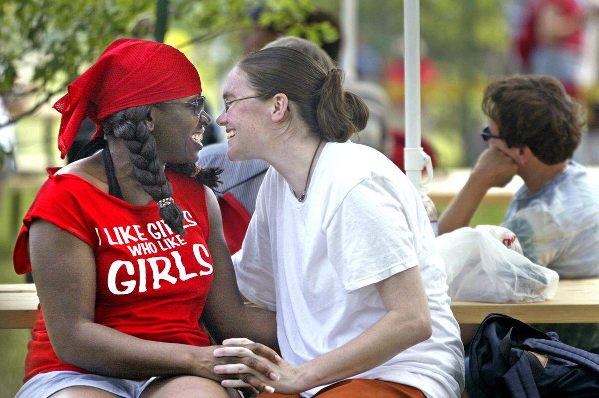 Amid the bustle of activity at the Kansas City Gay Pride Festival, Eulonda Moore, left, and Megan Forbes of Kansas City shared time together in 2005.