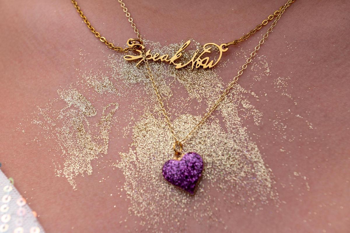 Thirteen-year-old Brylie Kenkel showcases a “Speak Now” neckless while waiting in line at Taylor Swift’s Eras Tour stop at GEHA Field at Arrowhead Stadium on Friday, July 7, 2023, in Kansas City.