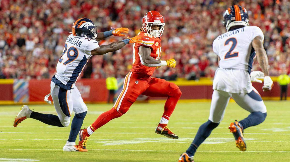 Kansas City Chiefs running back Isiah Pacheco (10) runs the ball as Denver Broncos cornerback Ja’Quan McMillian (29) gives chase during an NFL football game at GEHA Field at Arrowhead Stadium on Thursday, Oct. 12, 2023, in Kansas City.