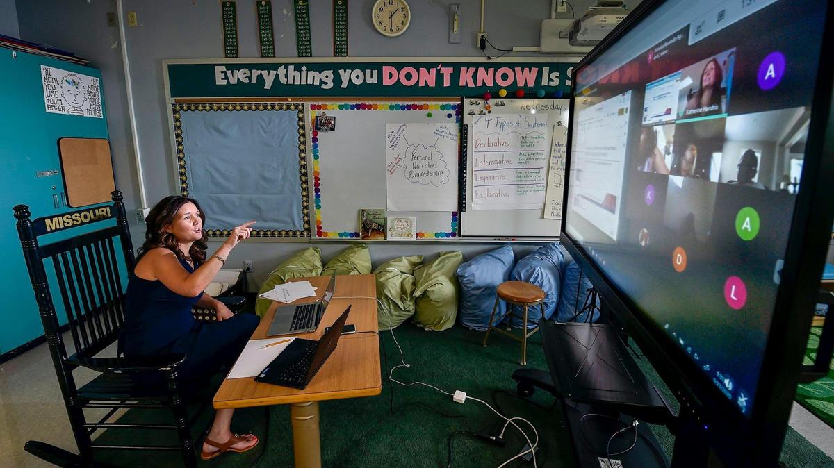 In an empty classroom, Katherine Hendrix, a third-grade teacher at J.A. Rogers Elementary, instructs students virtually on Wednesday, Sept. 23, 2020, using a large screen. 