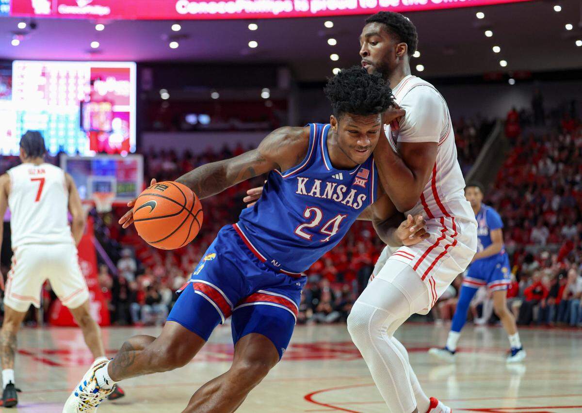 Kansas Jayhawks forward KJ Adams Jr. (No. 24) drives against Houston Cougars forward Ja’Vier Francis during a Big 12 college basketball game at the Fertitta Center in Houston on Monday, March 3, 2025.