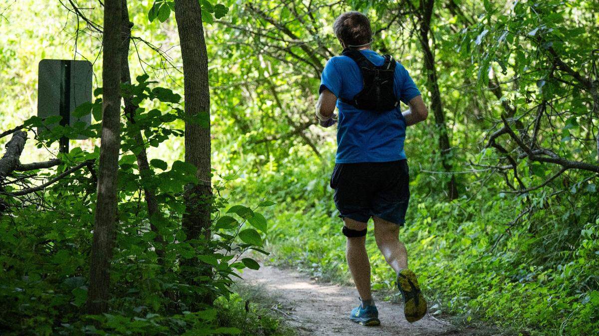 A jogger runs along the Hidden Valley Trail in Kansas City.
