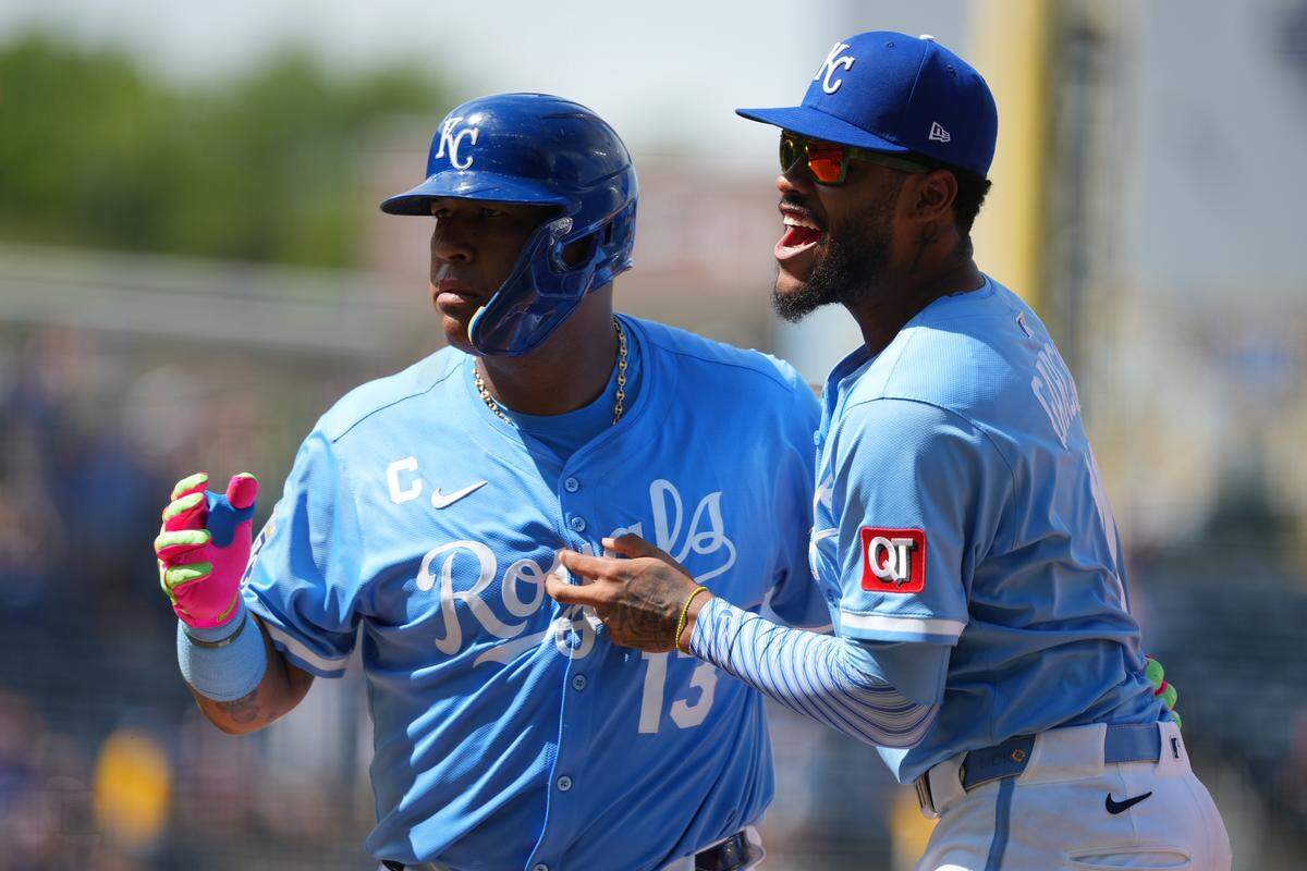 Royals catcher Salvador Perez, left, celebrates his walk-off RBI single with Maikel Garcia in a game against the Atlanta Braves at Kauffman Stadium in Kansas City on July 30, 2025.