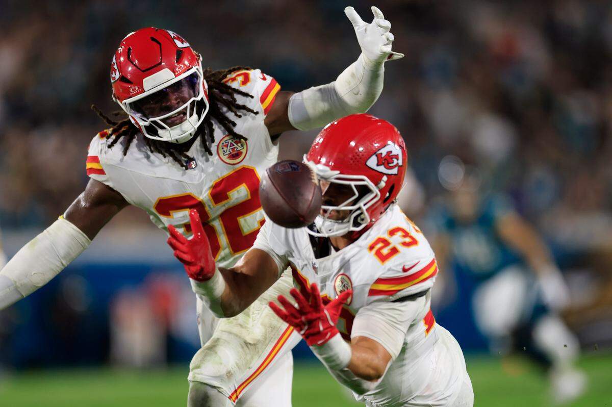 Kansas City Chiefs linebackers Nick Bolton (No. 32) and linebacker Drue Tranquill (No. 23) can’t intercept a bobbled pass during an NFL game against the Jaguars at EverBank Stadium in Jacksonville, Florida on Monday, Oct. 6, 2025.