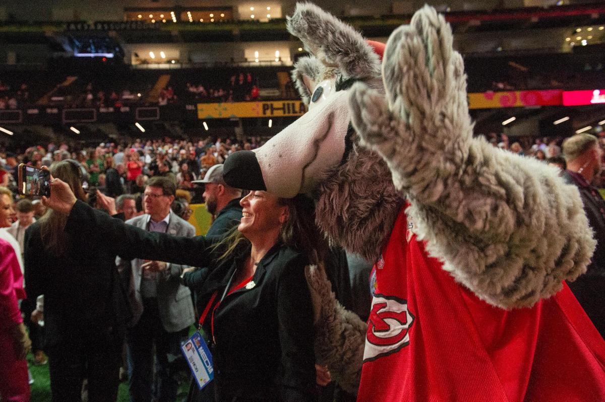 A member of the press takes a photo with KC Wolf during opening night of the Super Bowl at Caesars Superdome in New Orleans on Monday, Feb. 3, 2025.