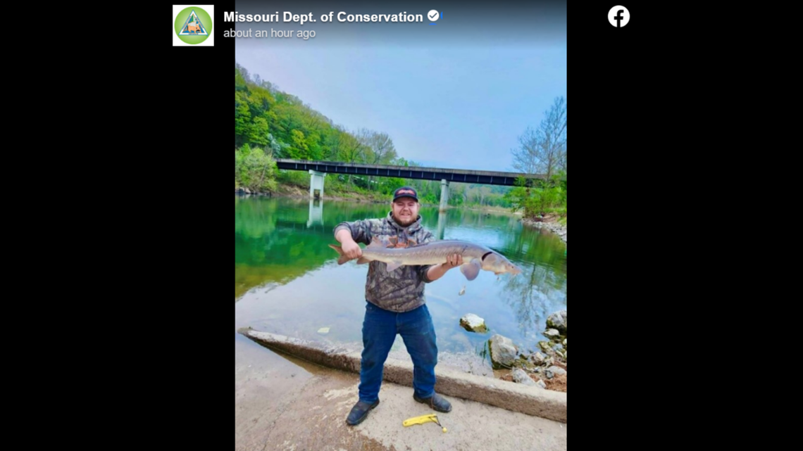 Chandler Lee Tudor with a lake sturgeon fish.