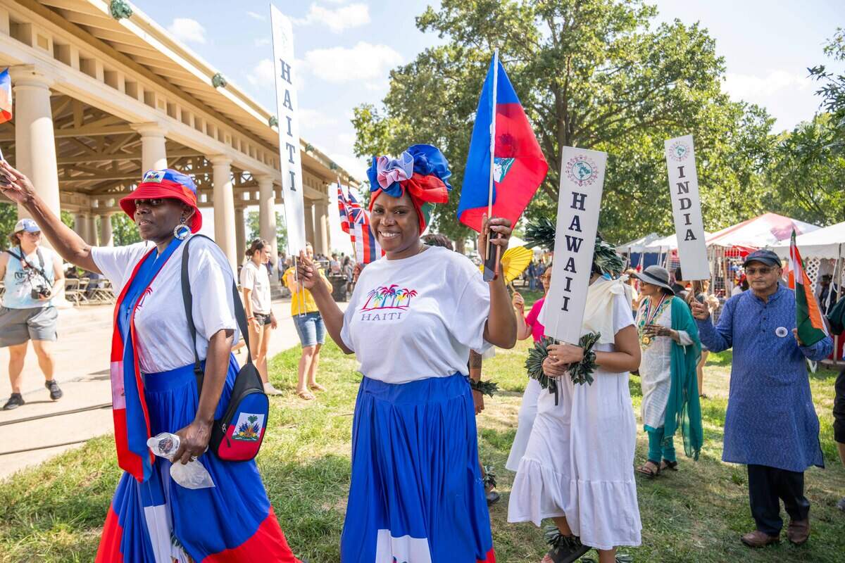 People of different ethnicities participate in the parade of flags at the Ethnic Enrichment Festival in Swope Park on Saturday, Aug. 16, 2025, in Kansas City.