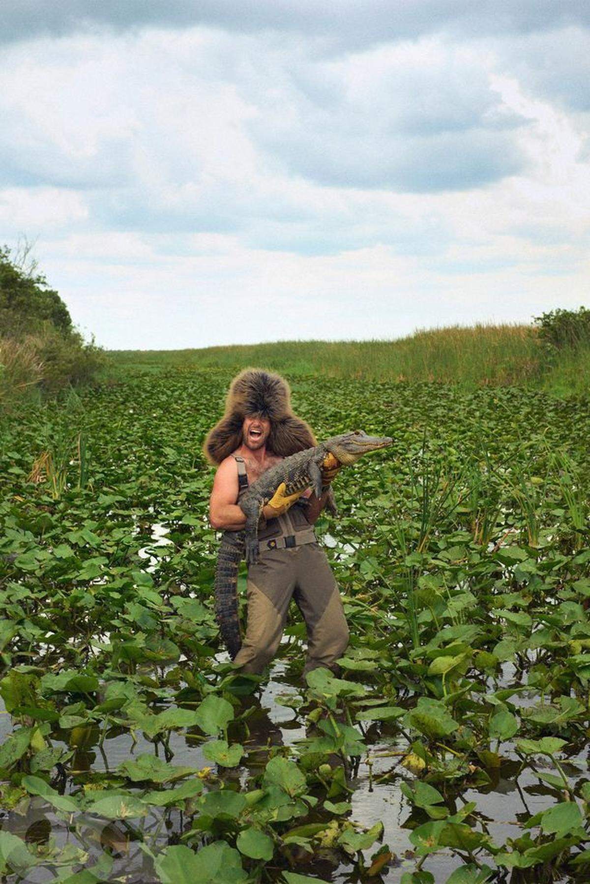 One of Travis Kelce’s photos shows him in a swamp holding an alligator. The Chiefs tight end was in Florida during the offseason, which helped inspire the photos.
