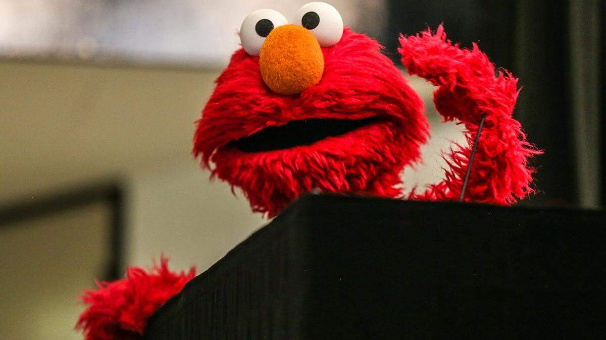 Elmo joins Detroit Symphony Orchestra musicians to teach a group of children at Fleming Early Learning Center in Detroit on Thursday, June 20, 2019 about the fundamentals of music like tempo and rhythm as a part of the Sesame Street Workshop national road trip to celebrate their 50th anniversary.