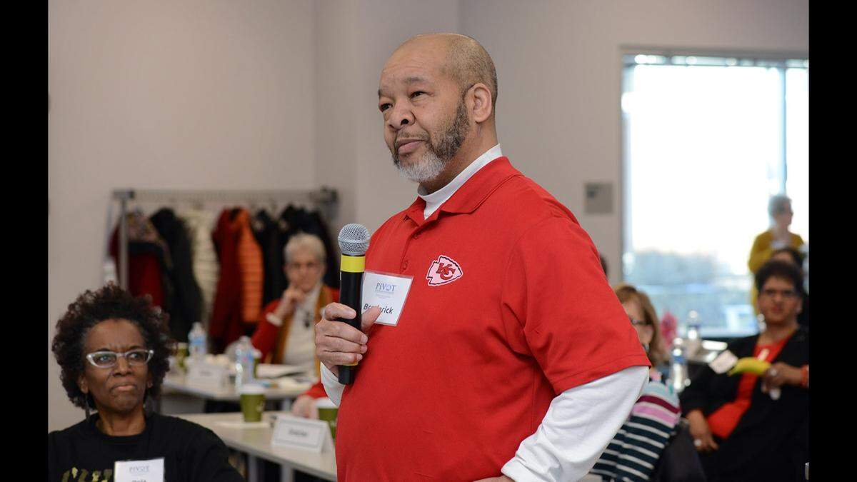Broderick Crawford is pictured speaking to community members in a Kansas City Chiefs shirt. He served on over 25 committees and task forces across the Kansas City area.