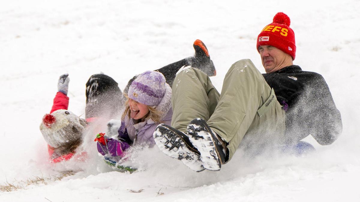 Grant Wiens of Overland Park spent a snow day sledding with his daughters Kenzie, 9, and Reagan, 6, on Wednesday, Feb. 12, 2025, at Meadowbrook Park in Prairie Village.
