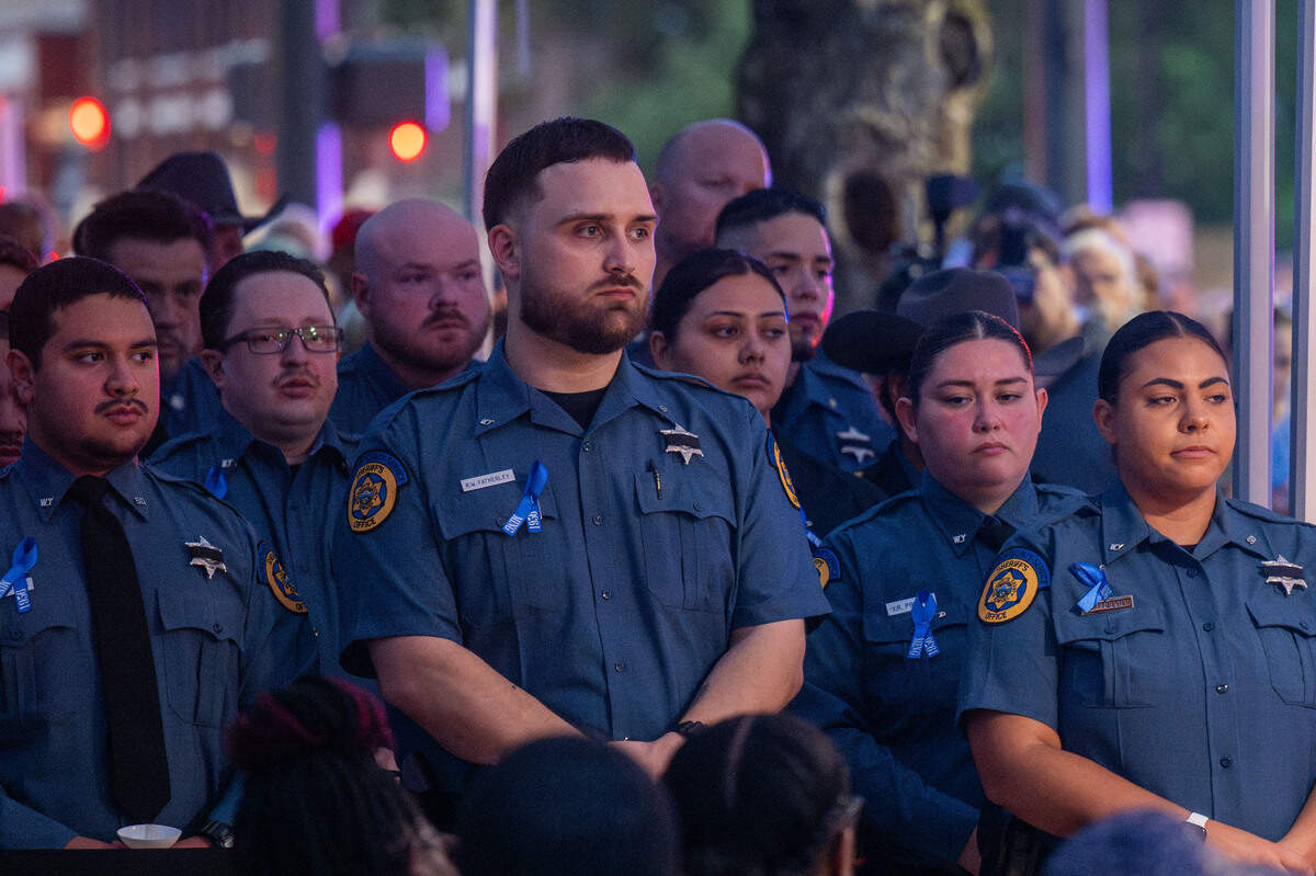 Members of the Wyandotte County Sheriff’s department stand solemnly in a show of support for Elijah Ming’s family and friends.