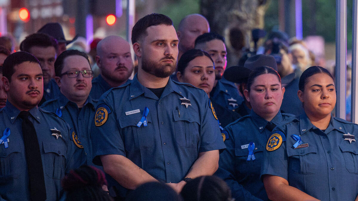 Members of the Kansas City, Kansas Sheriff’s department stand solemnly during a candlelight vigil held for slain KCK sheriff’s deputy Elijah Ming outside the Wyandotte County Courthouse on Wednesday, July 30, 2025. The nearly nine-year veteran died in the line of duty on Saturday, July 26, 2025.