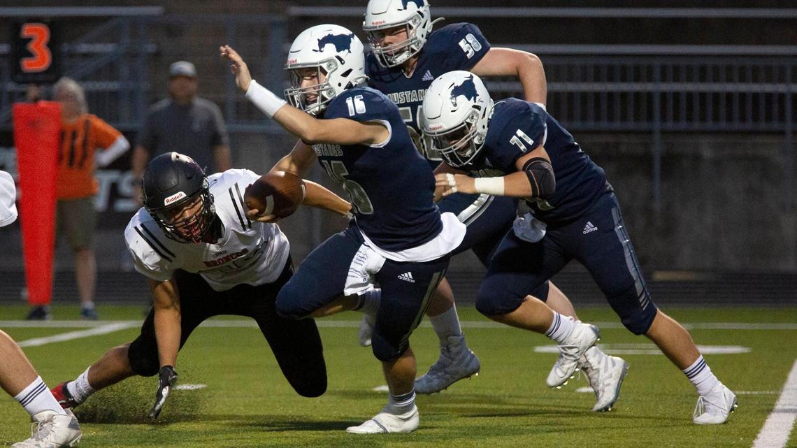 Blue Valley North quarterback Henry Martin carries the ball during a September game against Lee’s Summit North.