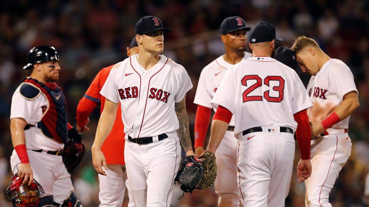 Boston Red Sox’s Tanner Houck, center, left, leaves the mound after being taken out during the fifth inning of a baseball game against the Minnesota Twins, Tuesday, Aug. 24, 2021, in Boston. (AP Photo/Michael Dwyer)