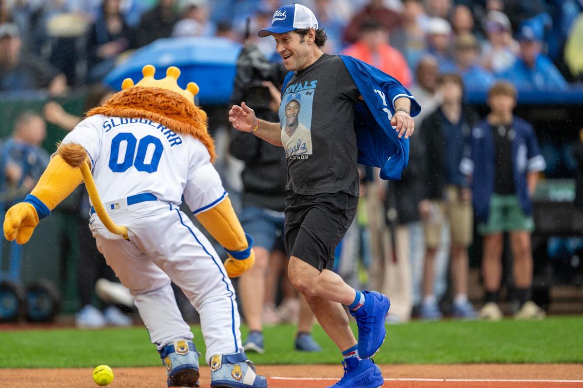 Actor Paul Rudd runs to home plate while Kansas City Royals mascot Sluggerrr attempts to field the ball during the Big Slick celebrity softball game at Kauffman Stadium on Friday, May 31, 2024, in Kansas City.